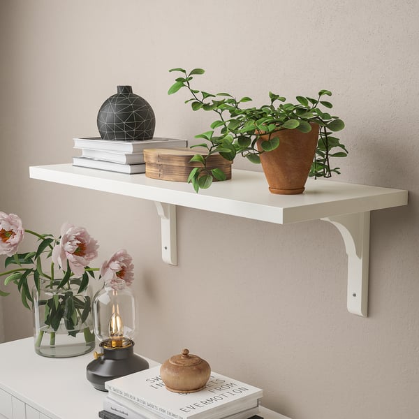 White wall shelf, displaying plants, books, and decor. Supports up to 10kg, evenly distributed.