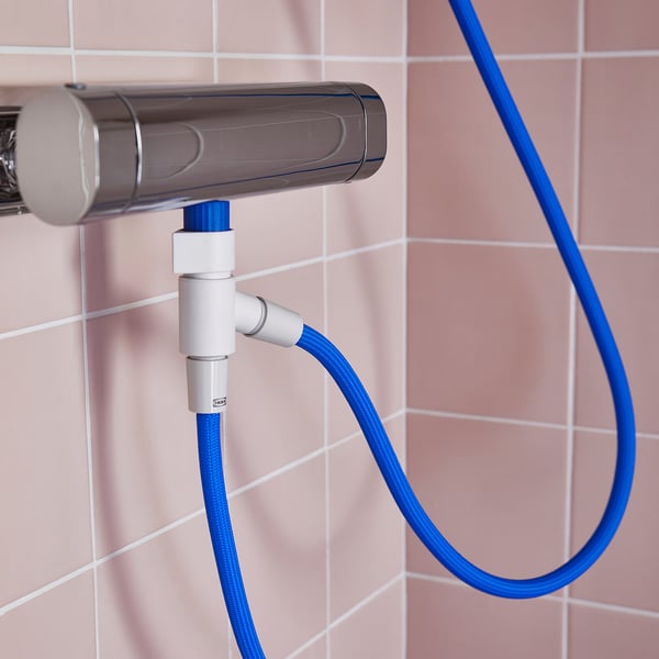Silver shower diverter with blue hose attached. Connected to wall, hose hangs loosely.