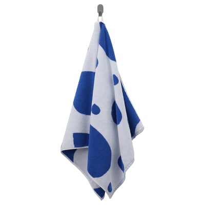 Blue/white towel with drop pattern hangs on hook.