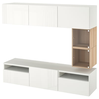 An ikea BESTÅ tv bench in white with a wooden cabinet. It has multiple compartments for storage and cable management.