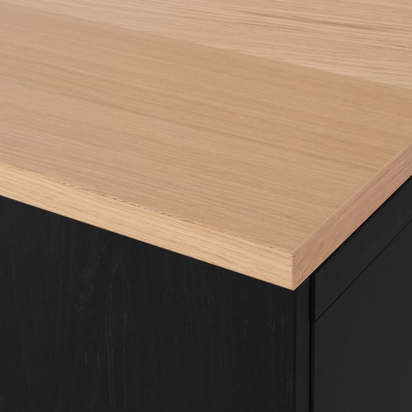 Close-up of modern furnitures sleek, wooden top. Light wood on dark base, polished finish.