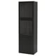 A black BESTÅ cabinet with glass doors and drawers for storing and displaying items. It a sleek design with tempered glass and particleboard.