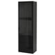 A tall, black BESTÅ storage unit with glass doors for display and storage. It modern design with drawers and adjustable shelves.