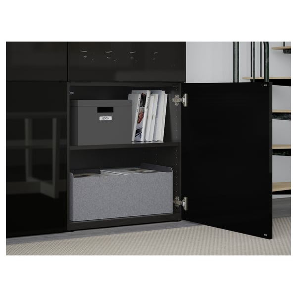 Black cabinet with glass doors showing books and storage bins inside; shelves adjustable and hinges allow door alignment.