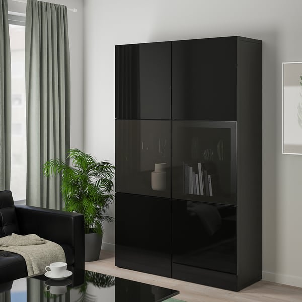 High-end black BESTÅ cabinet: tall, rectangular with glass doors & shelves. Display & hide items. Soft-close doors. Plants & cups nearby.