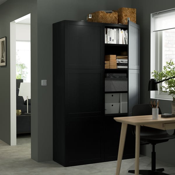 Modern black storage cabinet with open shelves holding books and boxes. Designed for organising home office essentials.