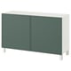 An ikea BESTÅ sideboard in green and white with two doors and square legs.