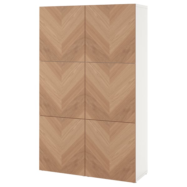 A white BESTÅ storage cabinet with six light wooden doors featuring a herringbone pattern.