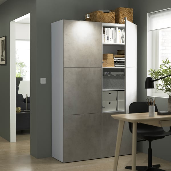 Modern grey and white storage cabinet in home office, with adjustable shelves and books.