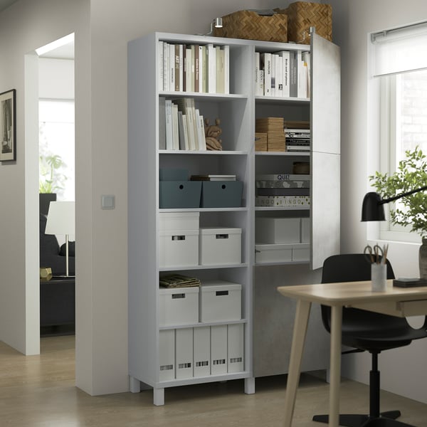 Modern BESTÅ storage unit in home office with books and decor.