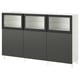 A BESTÅ storage unit in white and dark grey. It three sections with glass doors and solid panels. Modern design with adjustable shelves.
