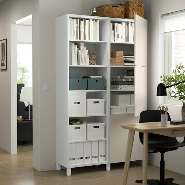 Bookshelf with adjustable shelves, open and closed storage. Organises items neatly, featuring both visible display and hidden storage compartments.