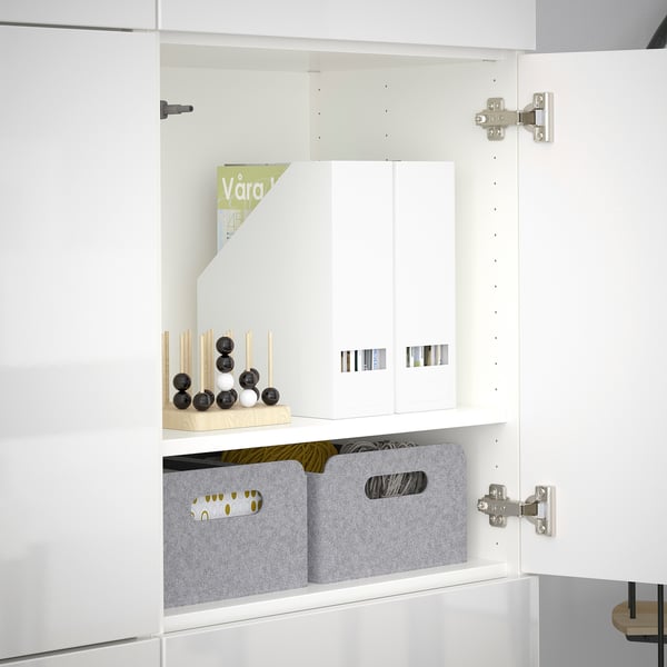 Open BESTÅ cabinet reveals adjustable shelves, containers, and decorative items. Hinges allow door adjustments.