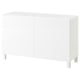 Ikea BESTÅ white cabinet: simple, rectangular shape with two doors, raised on four legs, minimalist design for storage.