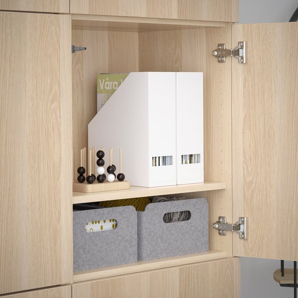 Wooden cabinet with adjustable shelves, grey bins, and a white organiser. Soft-close hinges visible.