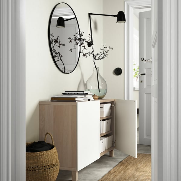 Modern entryway with BESTÅ storage, mirror, light, and basket.