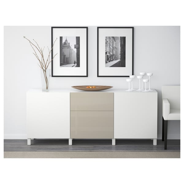 Modern sideboard with two drawers, decorative bowl, and framed art against white wall, providing storage and organisation.