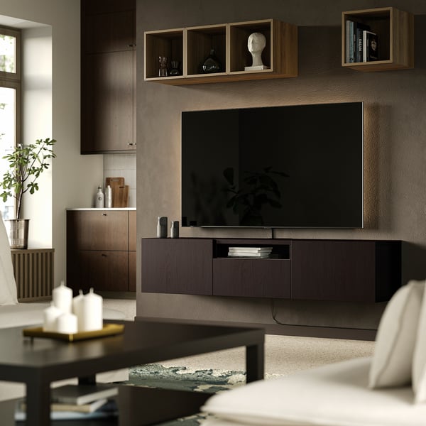 Modern living room with BESTÅ tv bench, dark brown, flat-screen tv, and minimalist decor.