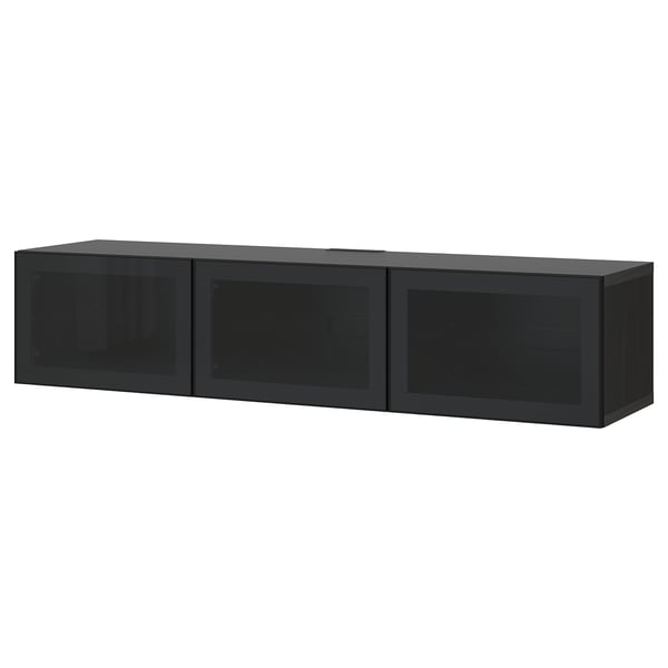 A black BESTÅ tv bench with three glass doors. It has a sleek, modern design and provides ample storage space.