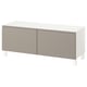 Depicts a white and beige BESTÅ tv bench with two sliding doors and adjustable shelves, designed for neat cable management.