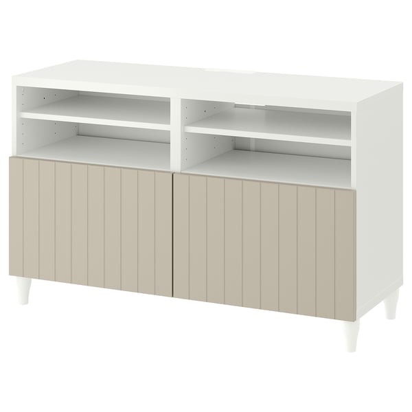 A white BESTÅ tv bench with adjustable shelves and cable outlets. It has a modern design with vertical grooves on the cabinet doors.