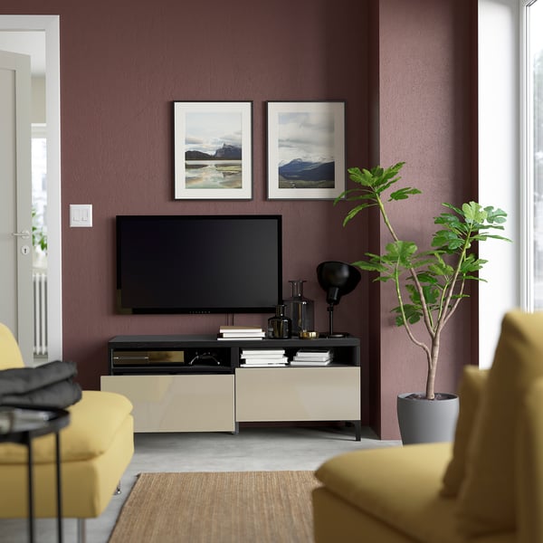 Modern living room with BESTÅ tv bench, flat screen, decor, mountain prints, plant.