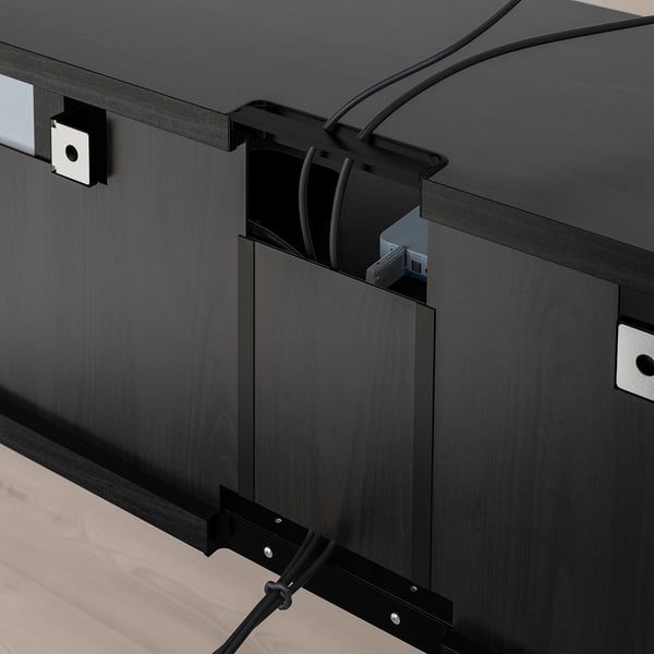 Black tv stand with adjustable shelves and cable management, showing open slot for cords.