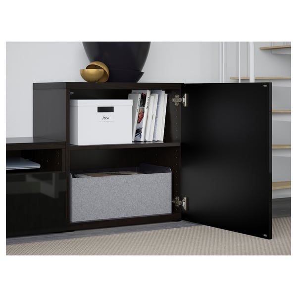 Black BESTÅ tv storage cabinet with open door revealing organised shelves.