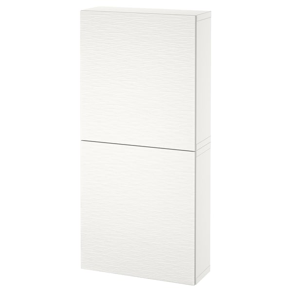 Displays a white BESTÅ wall cabinet with two doors, a sleek design, and soft-close or push-open functionality.