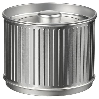 Silver metal container with grooved design and knobbed lid.