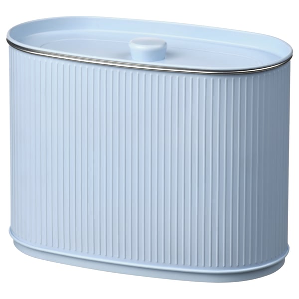 A white, oval-shaped storage bin with a fluted design, made of tinplated steel, and a handle on the lid.