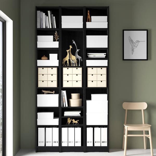 Black BILLY bookcase with boxes, books, and decor.