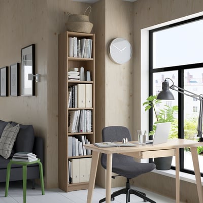 Modern office with BILLY bookcase, laptop desk, and cosy decor.