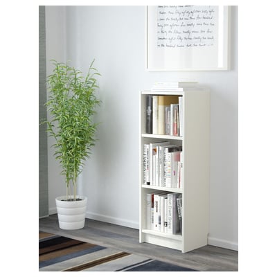 White BILLY bookshelf with books and plant.