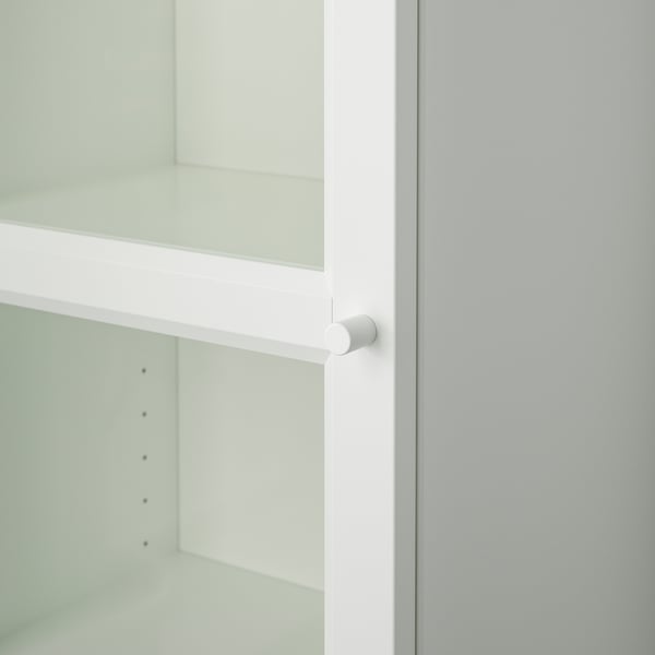 Close-up of BILLY bookcase hinge, showcasing quality white finish and smooth mechanism.