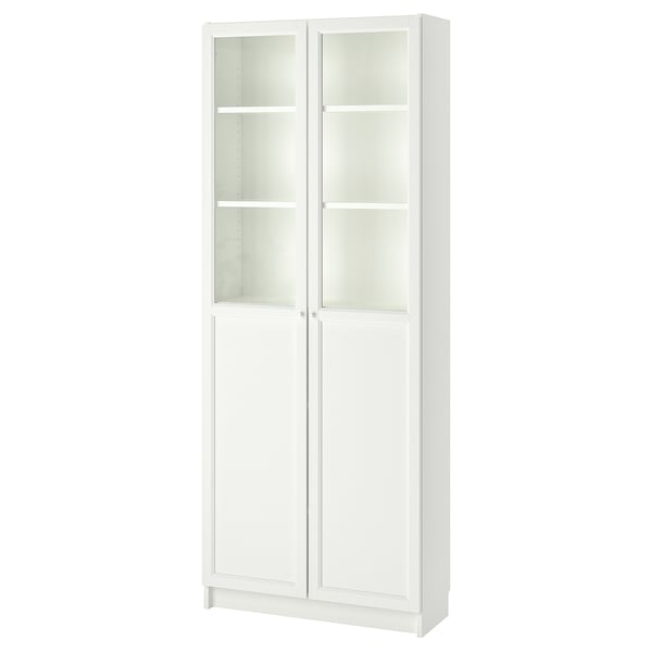 A white BILLY bookcase with glass doors. It a simple design with four adjustable shelves, suitable for versatile storage and display.