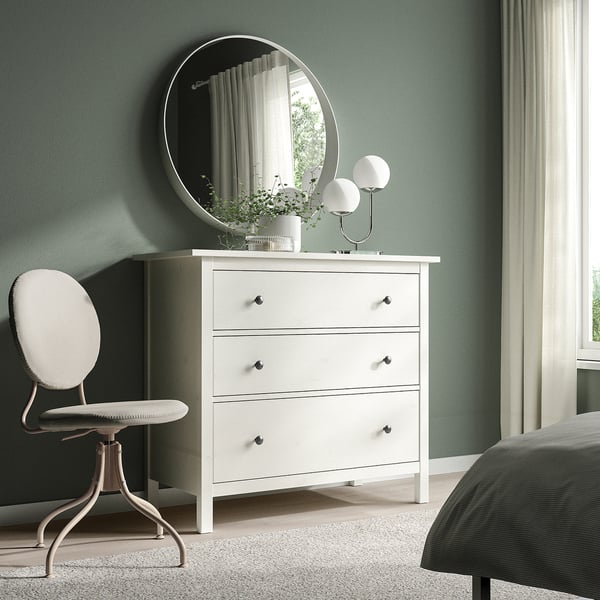 Minimalist bedroom with BJÖRKBERGET chair, hemnes dresser, and calming green walls.