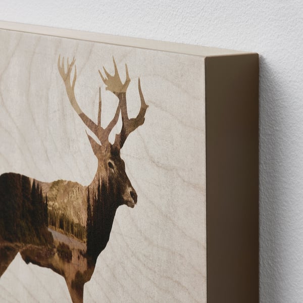Canvas print of a deer head on textured wall art with a brown frame.