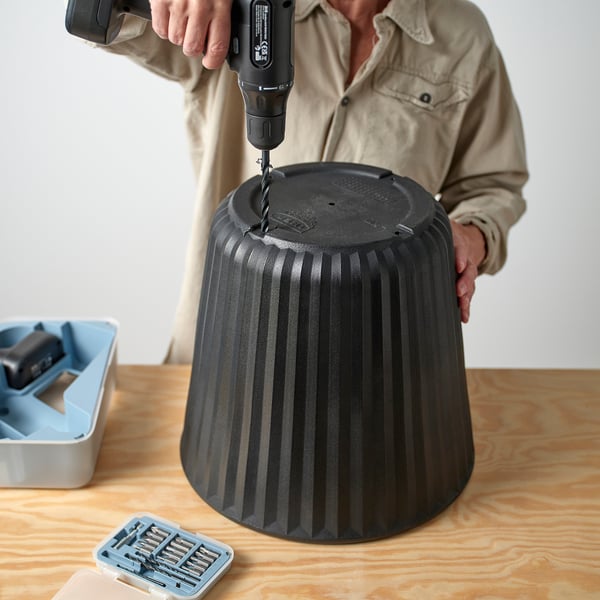 Drilling BJÖRNBAMBU pots bottom on table. Lightweight, versatile.