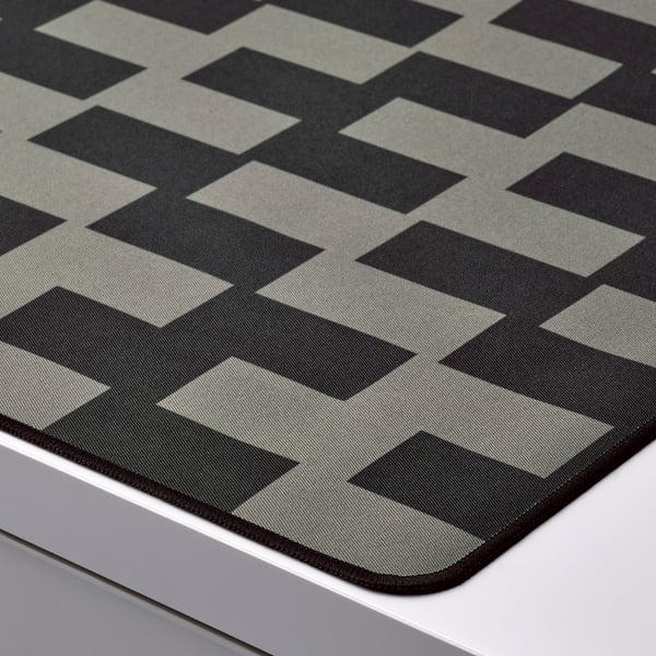 Close-up of textured black & grey chequered gaming mouse pad on a desk, showcasing premium fabric and stitching.