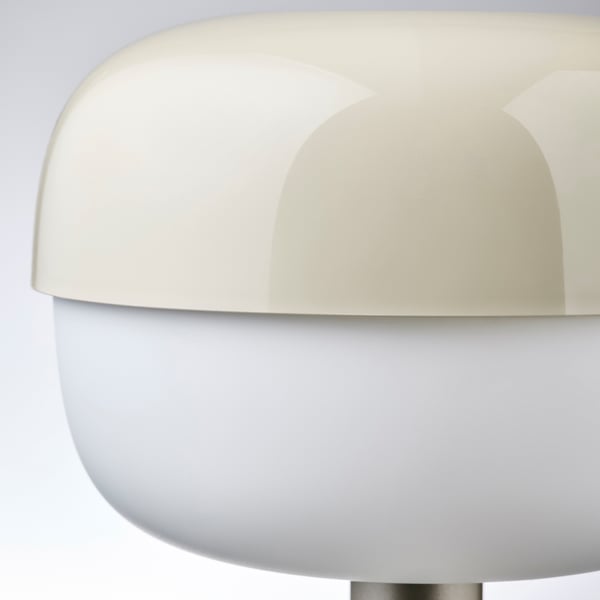 Modern lamp with smooth, curved design, predominantly white, reflecting quality and elegance.