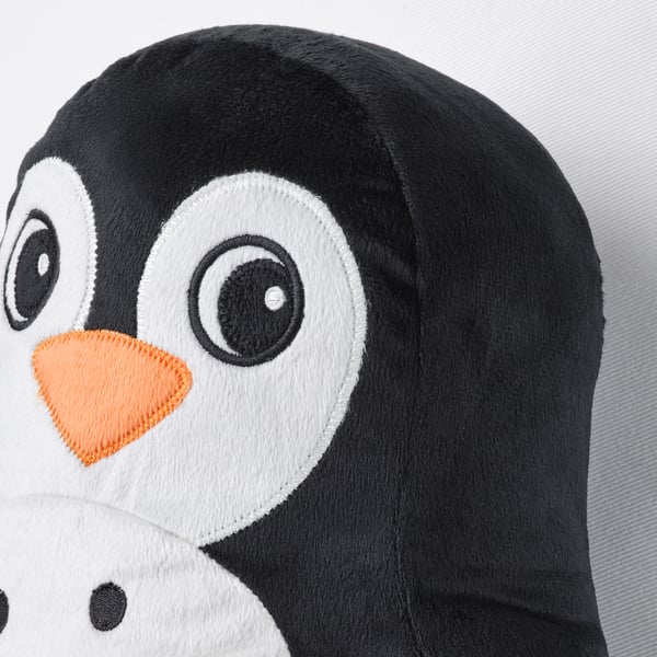 Soft penguin toy with large black eyes, bright orange beak, and fluffy black and white body on a white surface.