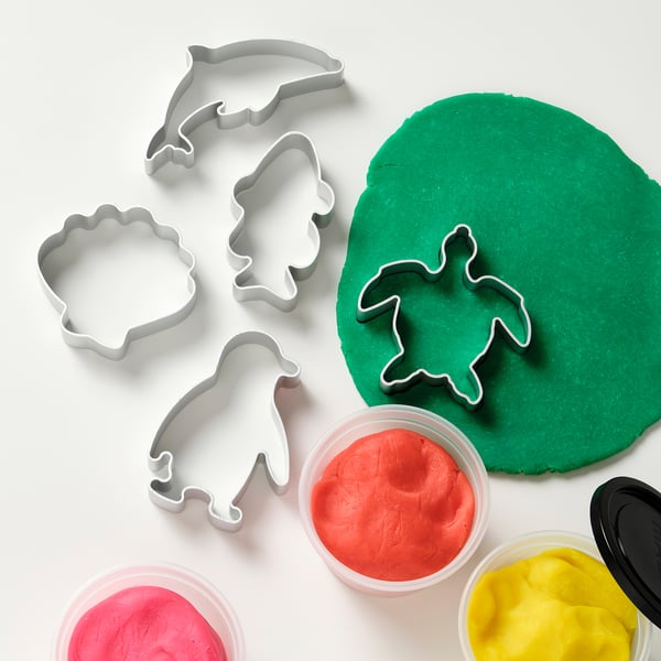 Playdough set with turtle cutter, promoting fine motor skills and creativity.