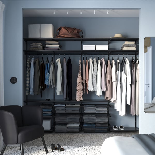 Closet with BOAXEL black steel organisers, hanging clothes, shelves, & storage bins.