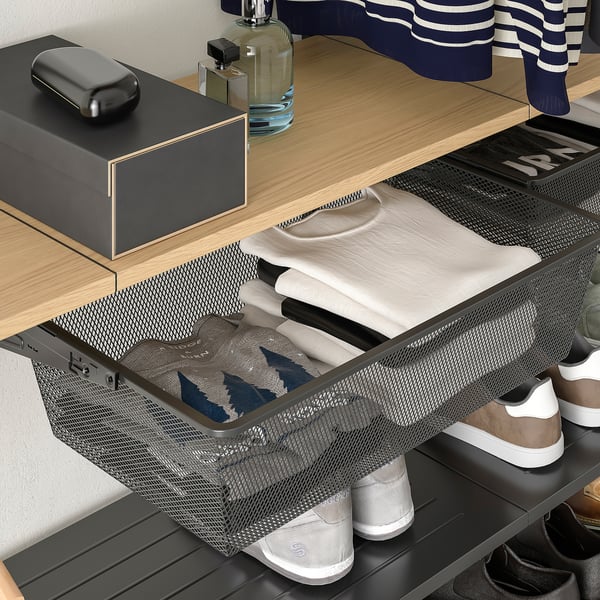 A BOAXEL storage system with a mesh basket holding folded clothes, neatly organized in a wardrobe.