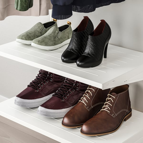 Shelves display diverse footwear: trainers, boots, and heels. Organised storage solution.