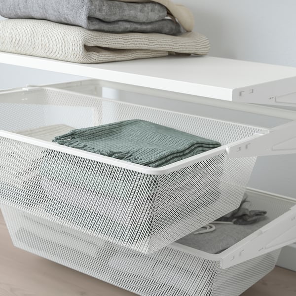 White mesh storage drawers hold folded clothes, neatly organised in a closet system.