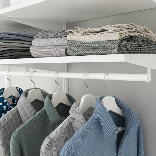 Closet with foldable shelves holding stacked clothes and hangers below.