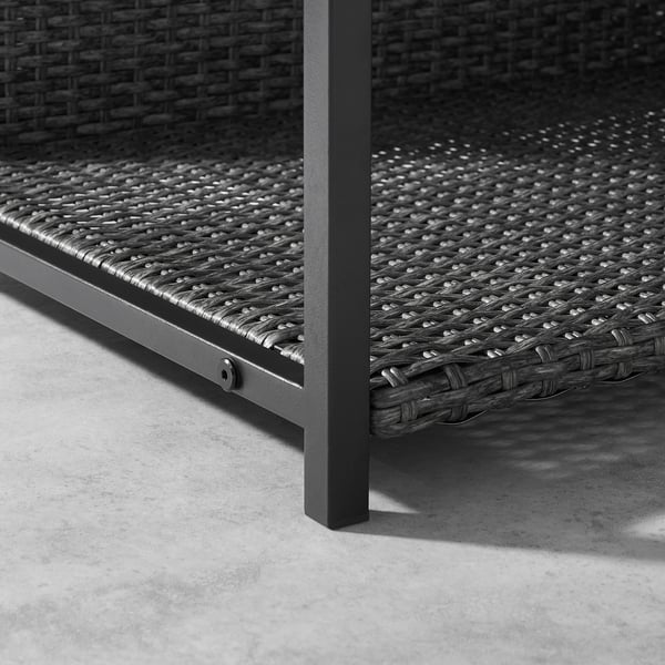 Black, woven outdoor dog bed with sturdy metal frame and feet, ensuring durability and comfort.