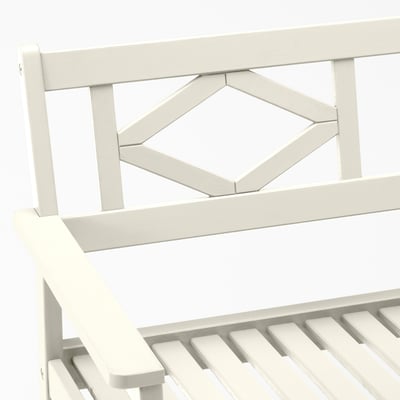 White outdoor bench with geometric backrest detail, sturdy acacia wood construction.